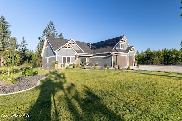 23426 N Massif Rd, Rathdrum, ID 83858 - craftsman-style home with board and batten siding, a front yard, concrete driveway, and a shingled roof