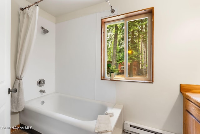 1053 Upper Pack River Rd, Sandpoint, ID 83864 - full bathroom with a baseboard heating unit, vanity, and shower / bathtub combination with curtain
