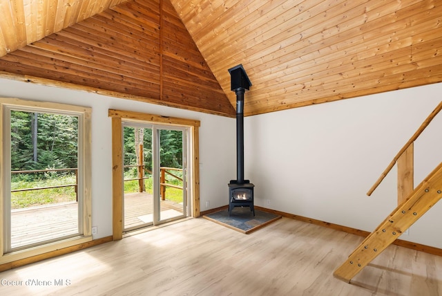 1053 Upper Pack River Rd, Sandpoint, ID 83864 - unfurnished living room with a wood stove, wood ceiling, healthy amount of natural light, high vaulted ceiling, and wood finished floors