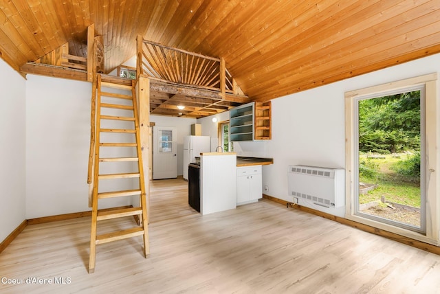 1053 Upper Pack River Rd, Sandpoint, ID 83864 - kitchen with heating unit, wooden ceiling, vaulted ceiling, open shelves, and light wood-style floors