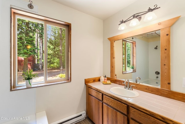 1053 Upper Pack River Rd, Sandpoint, ID 83864 - bathroom with healthy amount of natural light, a baseboard heating unit, vanity, and shower / washtub combination