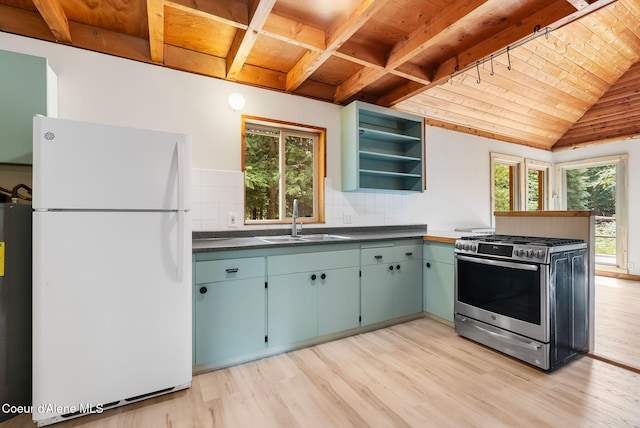 1053 Upper Pack River Rd, Sandpoint, ID 83864 - kitchen with freestanding refrigerator, gas stove, a wooden ceiling with exposed beams, light wood-style floors, and open shelves
