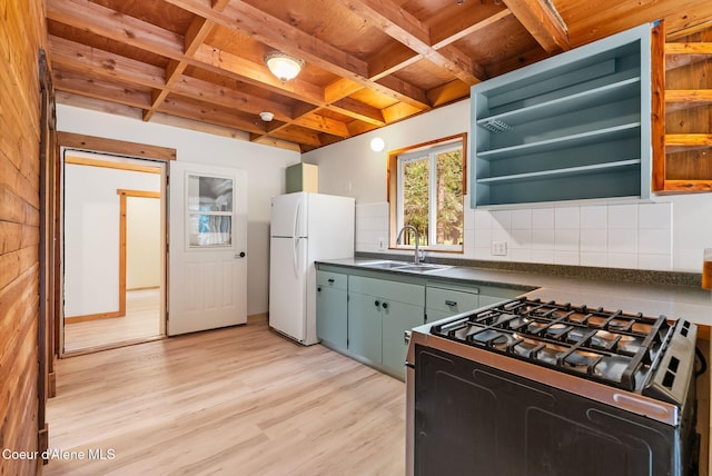 1053 Upper Pack River Rd, Sandpoint, ID 83864 - kitchen featuring stainless steel gas stove, a wood ceiling with exposed beams, freestanding refrigerator, dark countertops, and open shelves