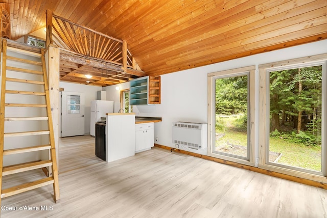 1053 Upper Pack River Rd, Sandpoint, ID 83864 - kitchen with heating unit, wooden ceiling, lofted ceiling, open shelves, and light wood-style floors