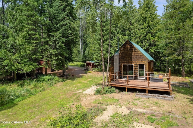 1053 Upper Pack River Rd, Sandpoint, ID 83864 - view of yard with a wooden deck and a wooded view