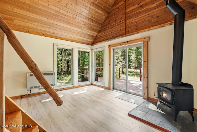 1053 Upper Pack River Rd, Sandpoint, ID 83864 - unfurnished living room with a wood stove, wooden ceiling, wood finished floors, and high vaulted ceiling