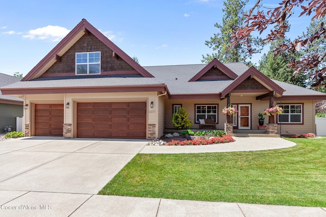 11477 N Rocking R Rd, Hayden, ID 83835 - craftsman-style house with a front lawn, concrete driveway, a shingled roof, stone siding, and an attached garage