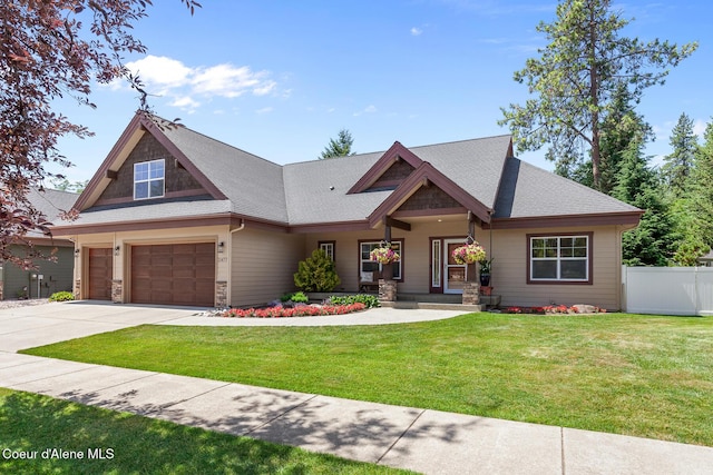 11477 N Rocking R Rd, Hayden, ID 83835 - craftsman-style house with driveway, an attached garage, roof with shingles, and covered porch