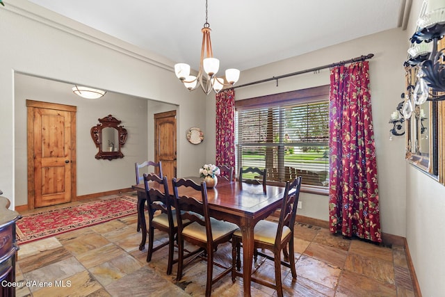 11477 N Rocking R Rd, Hayden, ID 83835 - dining space with stone tile flooring and a chandelier