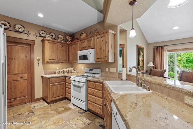 11477 N Rocking R Rd, Hayden, ID 83835 - kitchen featuring white appliances, light stone finish flooring, pendant lighting, recessed lighting, and brown cabinets