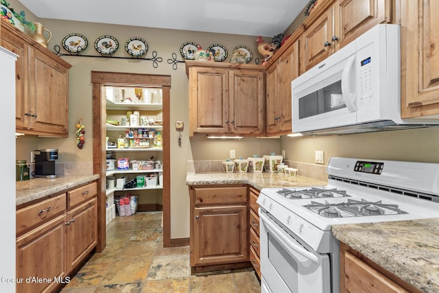11477 N Rocking R Rd, Hayden, ID 83835 - kitchen with white appliances, light stone finish flooring, and light stone countertops