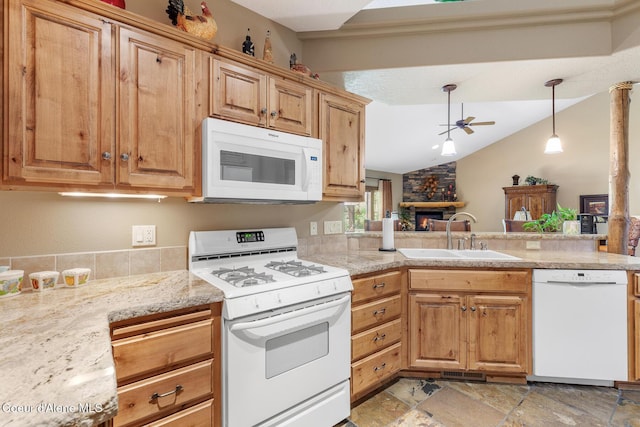 11477 N Rocking R Rd, Hayden, ID 83835 - kitchen featuring white appliances, vaulted ceiling, a ceiling fan, light stone finish floors, and a stone fireplace
