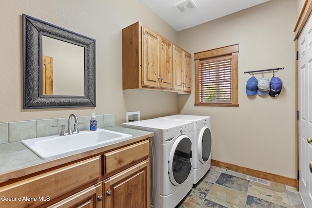 11477 N Rocking R Rd, Hayden, ID 83835 - laundry room featuring cabinet space, separate washer and dryer, and light stone finish flooring