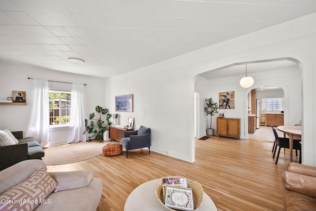 114 E Foster Ave, Coeur Dalene, ID 83814 - living room with arched walkways and light wood-style floors