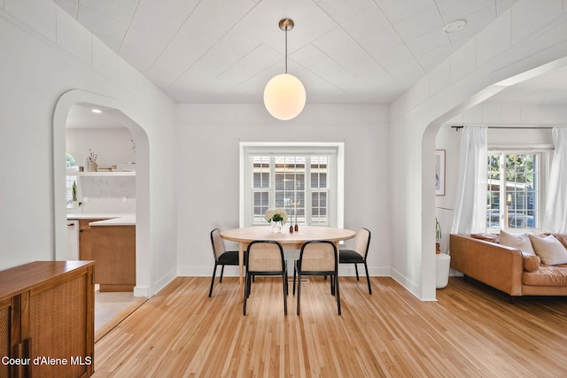 114 E Foster Ave, Coeur Dalene, ID 83814 - dining space with arched walkways and light wood-style flooring