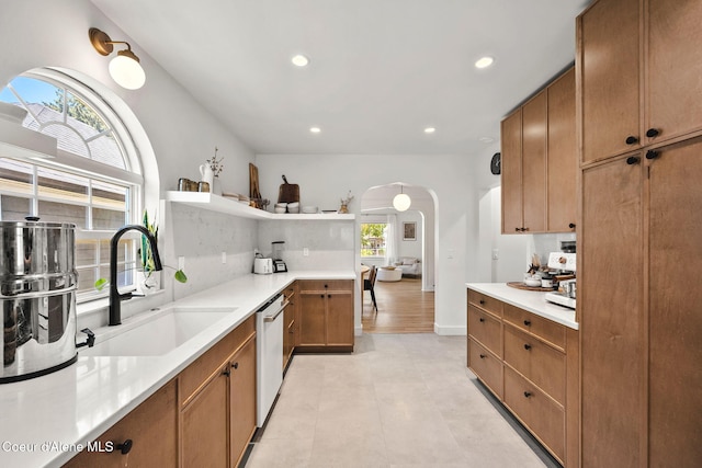114 E Foster Ave, Coeur Dalene, ID 83814 - kitchen featuring arched walkways, dishwasher, recessed lighting, light countertops, and brown cabinetry