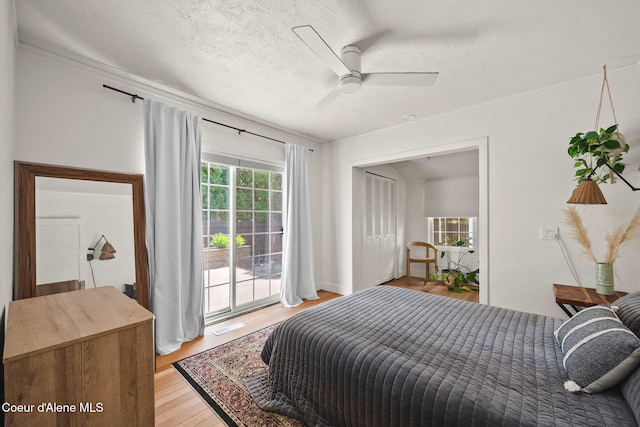 114 E Foster Ave, Coeur Dalene, ID 83814 - bedroom featuring access to exterior, light wood-style floors, crown molding, a textured ceiling, and a ceiling fan