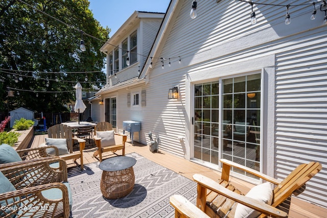 114 E Foster Ave, Coeur Dalene, ID 83814 - view of patio featuring a storage unit, outdoor dining area, a wooden deck, and outdoor lounge area