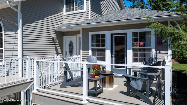 5570 E Shoreline Dr, Post Falls, ID 83854 - doorway to property featuring a shingled roof and a wooden deck
