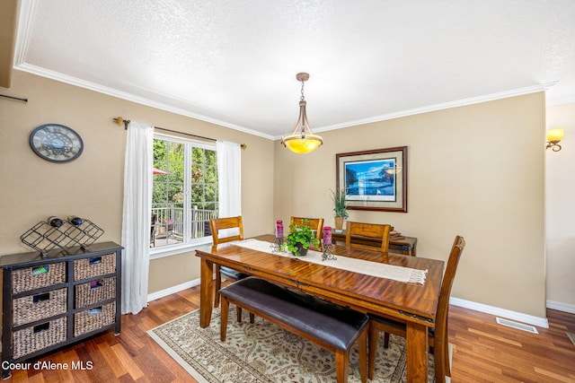 5570 E Shoreline Dr, Post Falls, ID 83854 - dining area with wood finished floors, ornamental molding, and a textured ceiling