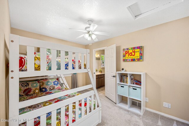 5570 E Shoreline Dr, Post Falls, ID 83854 - bedroom featuring light carpet, a textured ceiling, connected bathroom, attic access, and a ceiling fan