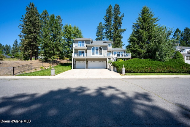 5570 E Shoreline Dr, Post Falls, ID 83854 - view of front of property with an attached garage, driveway, and a balcony