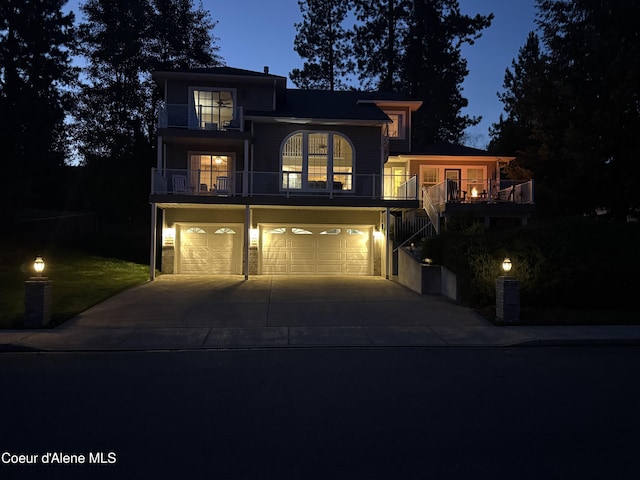 5570 E Shoreline Dr, Post Falls, ID 83854 - view of front facade with an attached garage, driveway, and stairway