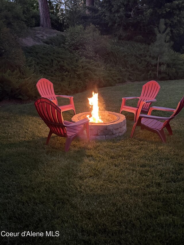 5570 E Shoreline Dr, Post Falls, ID 83854 - view of grassy yard with a fire pit
