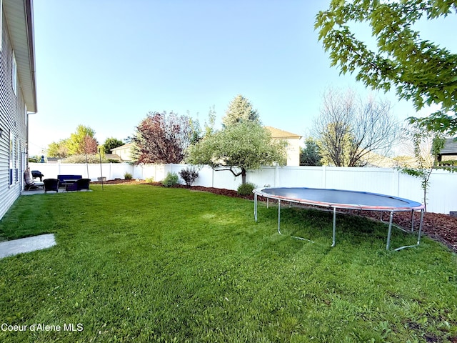 2699 E Thrush Dr, Post Falls, ID 83854 - fenced backyard featuring a trampoline