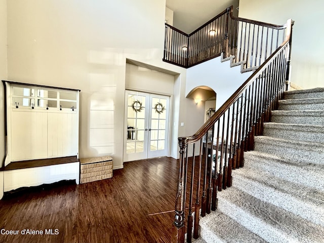 2699 E Thrush Dr, Post Falls, ID 83854 - stairs with arched walkways, wood finished floors, a high ceiling, and french doors