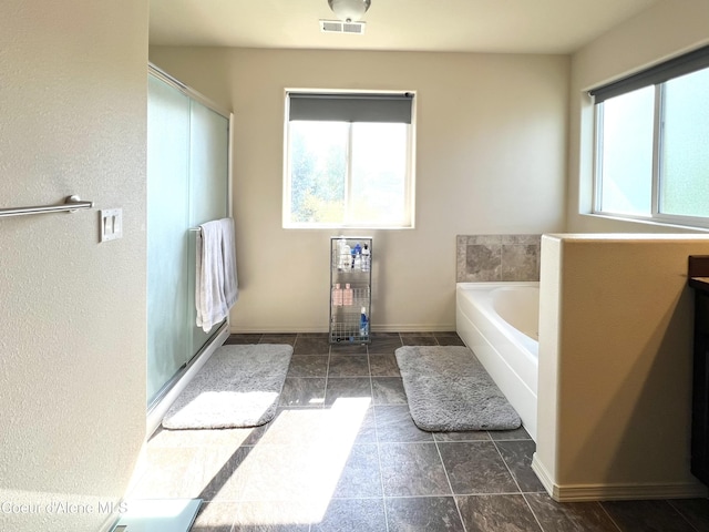 2699 E Thrush Dr, Post Falls, ID 83854 - bathroom with healthy amount of natural light, a bath, and a shower with shower door