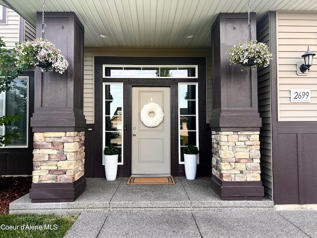 2699 E Thrush Dr, Post Falls, ID 83854 - view of exterior entry with stone siding and a porch
