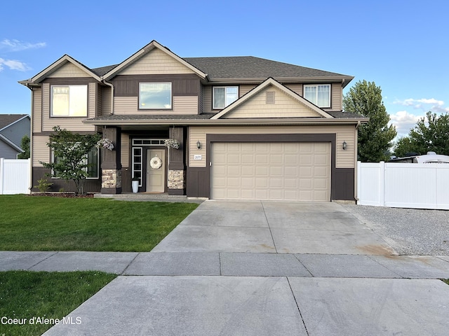 2699 E Thrush Dr, Post Falls, ID 83854 - craftsman-style house with concrete driveway, stone siding, and an attached garage