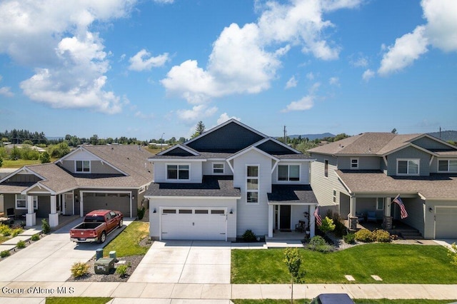 1839 N Skagit Dr, Post Falls, ID 83854 - craftsman-style home featuring driveway, a residential view, a front yard, a garage, and a shingled roof
