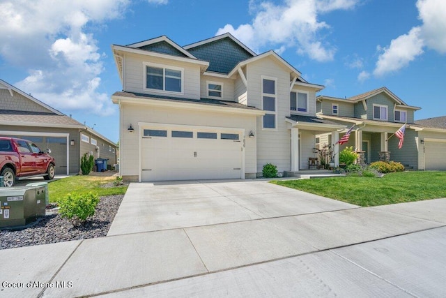 1839 N Skagit Dr, Post Falls, ID 83854 - craftsman-style house with concrete driveway, a front lawn, a garage, and a porch