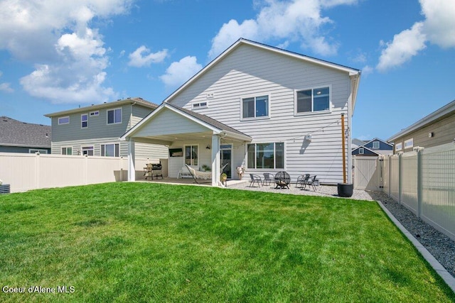 1839 N Skagit Dr, Post Falls, ID 83854 - back of house with a patio, a fenced backyard, and a gate