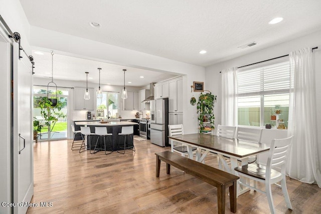 1839 N Skagit Dr, Post Falls, ID 83854 - dining room featuring light wood-style flooring, recessed lighting, and a barn door