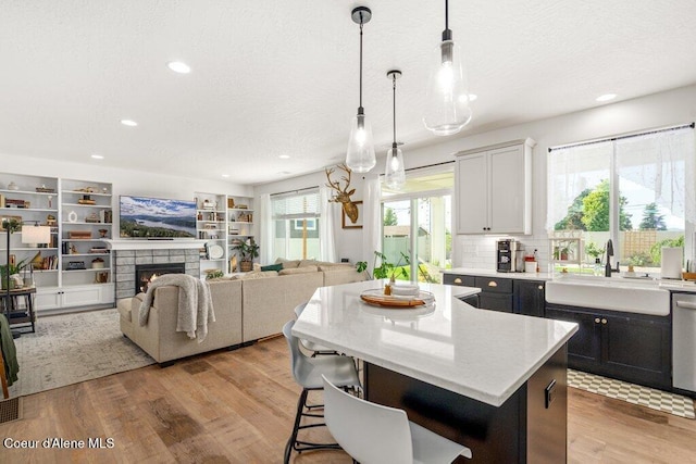 1839 N Skagit Dr, Post Falls, ID 83854 - kitchen featuring a kitchen island, a breakfast bar area, light wood-type flooring, pendant lighting, and recessed lighting