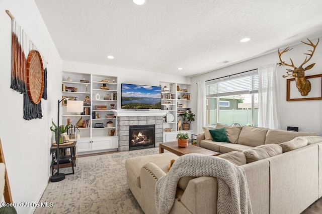1839 N Skagit Dr, Post Falls, ID 83854 - living room featuring a textured ceiling, a tiled fireplace, recessed lighting, and built in features