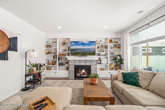 1839 N Skagit Dr, Post Falls, ID 83854 - living area featuring wood finished floors, a tiled fireplace, and recessed lighting