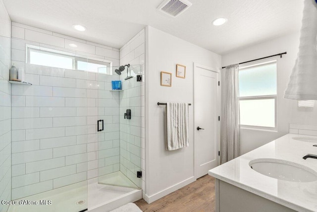 1839 N Skagit Dr, Post Falls, ID 83854 - bathroom with healthy amount of natural light, wood finished floors, a shower stall, double vanity, and recessed lighting