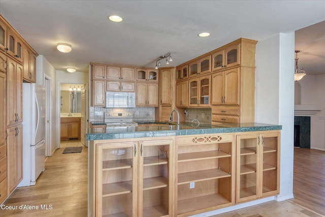 3789 N Steven Pl, Coeur Dalene, ID 83815 - kitchen with white appliances, light wood-type flooring, tasteful backsplash, glass insert cabinets, and recessed lighting
