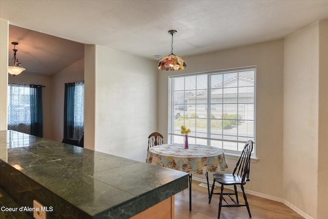 3789 N Steven Pl, Coeur Dalene, ID 83815 - dining area featuring light wood-style flooring and lofted ceiling