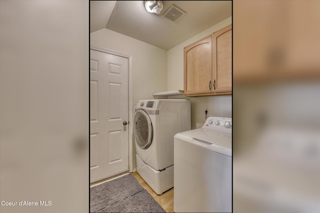 3789 N Steven Pl, Coeur Dalene, ID 83815 - washroom featuring washer and dryer, cabinet space, and light wood-style flooring