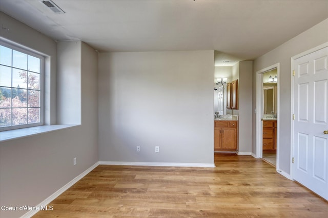 3789 N Steven Pl, Coeur Dalene, ID 83815 - unfurnished bedroom with light wood-style flooring and connected bathroom