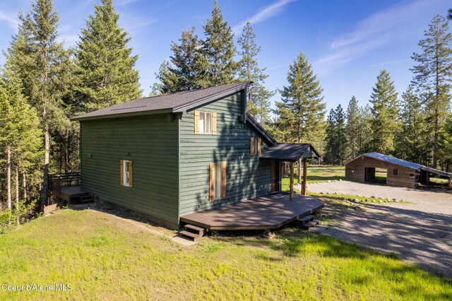 28729 Ramsey Rd, Athol, ID 83801 - view of home's exterior featuring a deck and a lawn