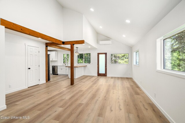 28729 Ramsey Rd, Athol, ID 83801 - unfurnished living room with a wall mounted AC, recessed lighting, high vaulted ceiling, and light wood-style flooring
