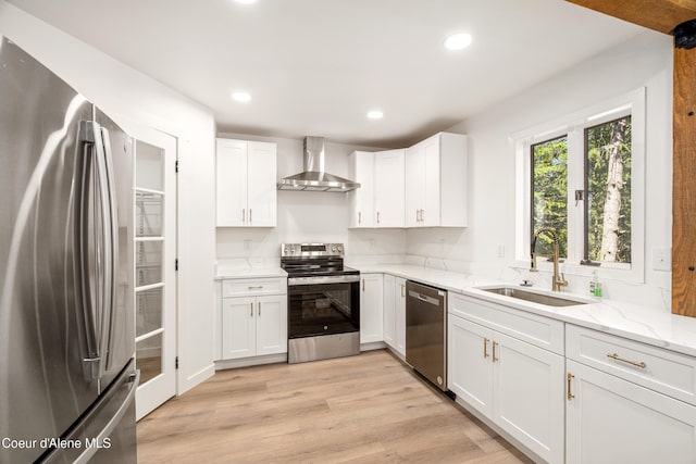 28729 Ramsey Rd, Athol, ID 83801 - kitchen featuring stainless steel appliances, wall chimney range hood, light stone counters, white cabinetry, and recessed lighting