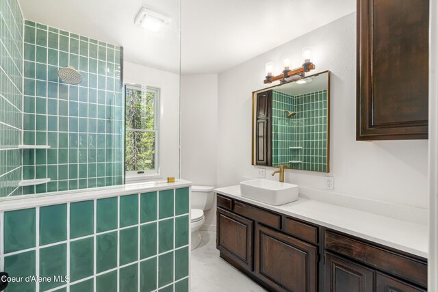 28729 Ramsey Rd, Athol, ID 83801 - bathroom with tiled shower, vanity, and marble finish flooring