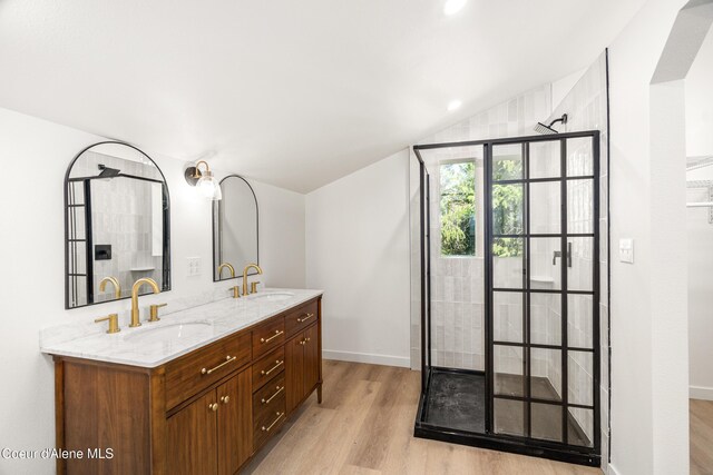 28729 Ramsey Rd, Athol, ID 83801 - bathroom with wood finished floors, a tile shower, double vanity, and vaulted ceiling